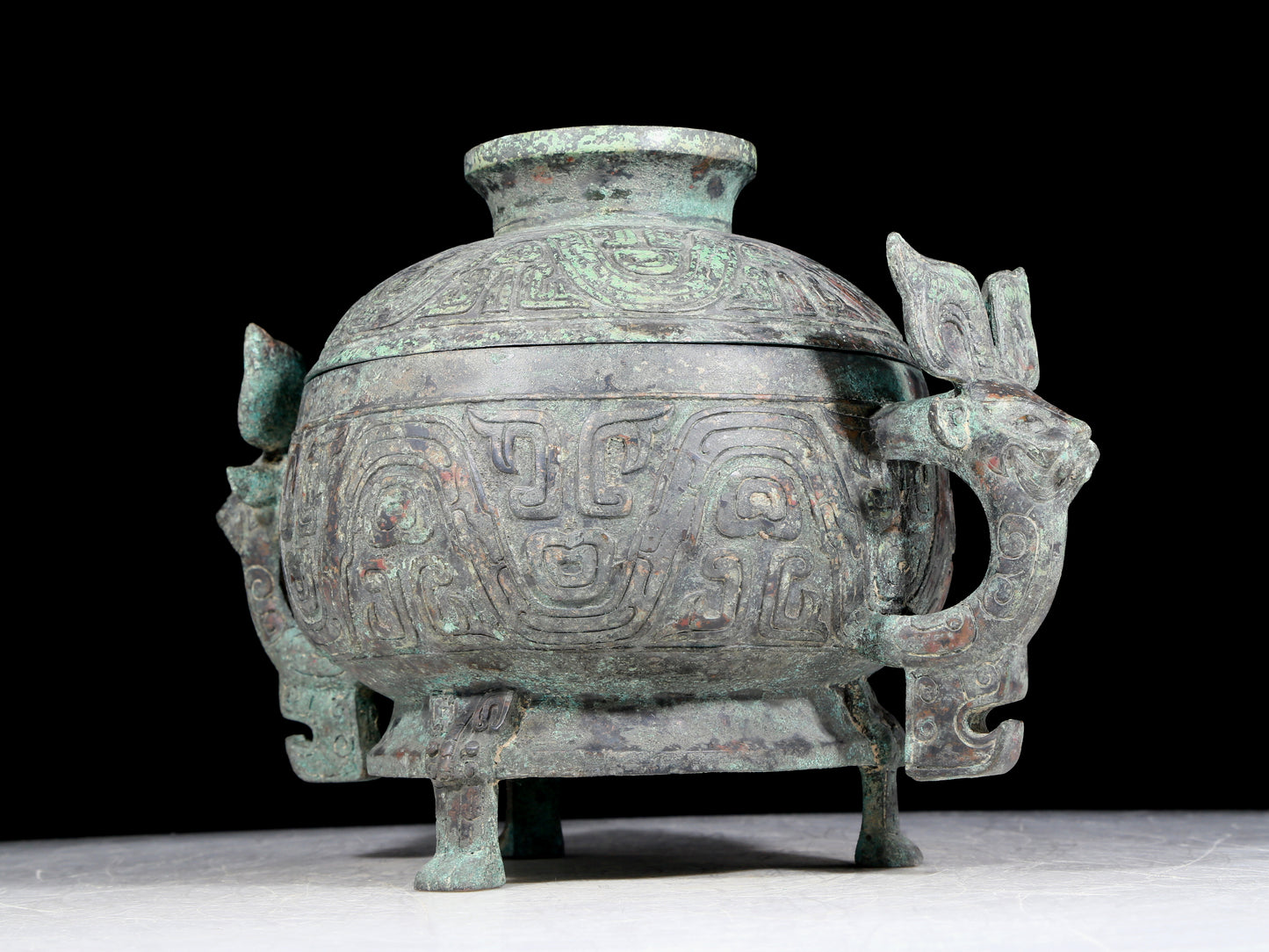 A precious bronze two-eared tripod furnace with auspicious animal patterns and a lid