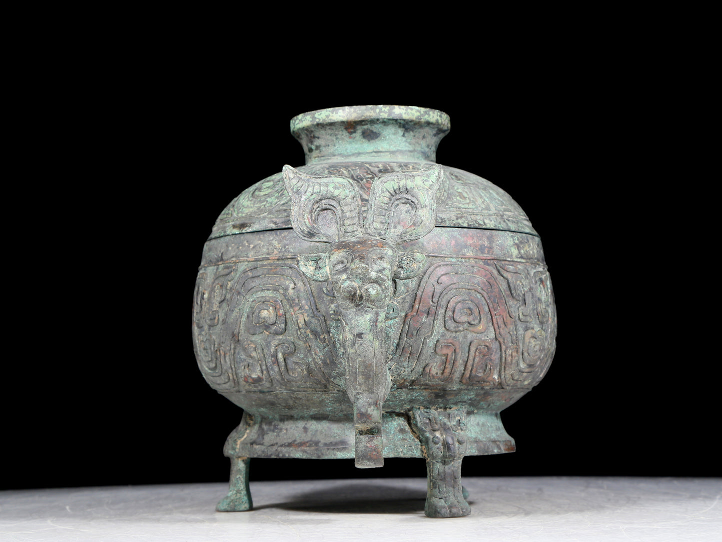 A precious bronze two-eared tripod furnace with auspicious animal patterns and a lid