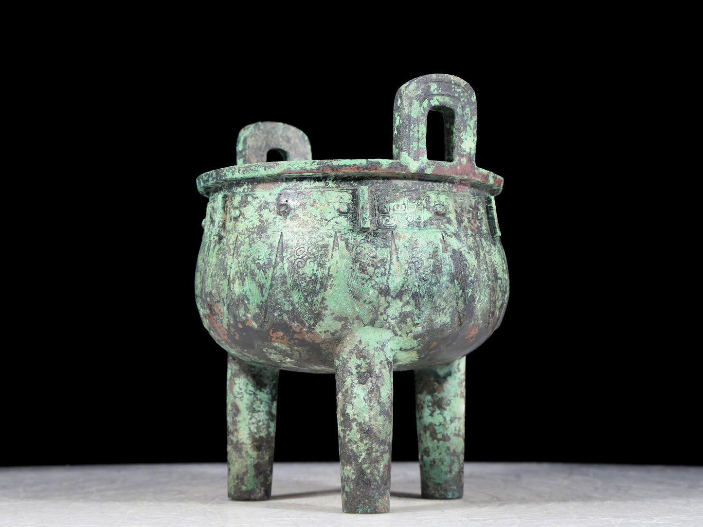 A precious bronze animal-faced two-eared and tripod furnace