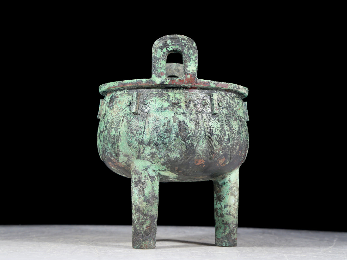 A precious bronze animal-faced two-eared and tripod furnace