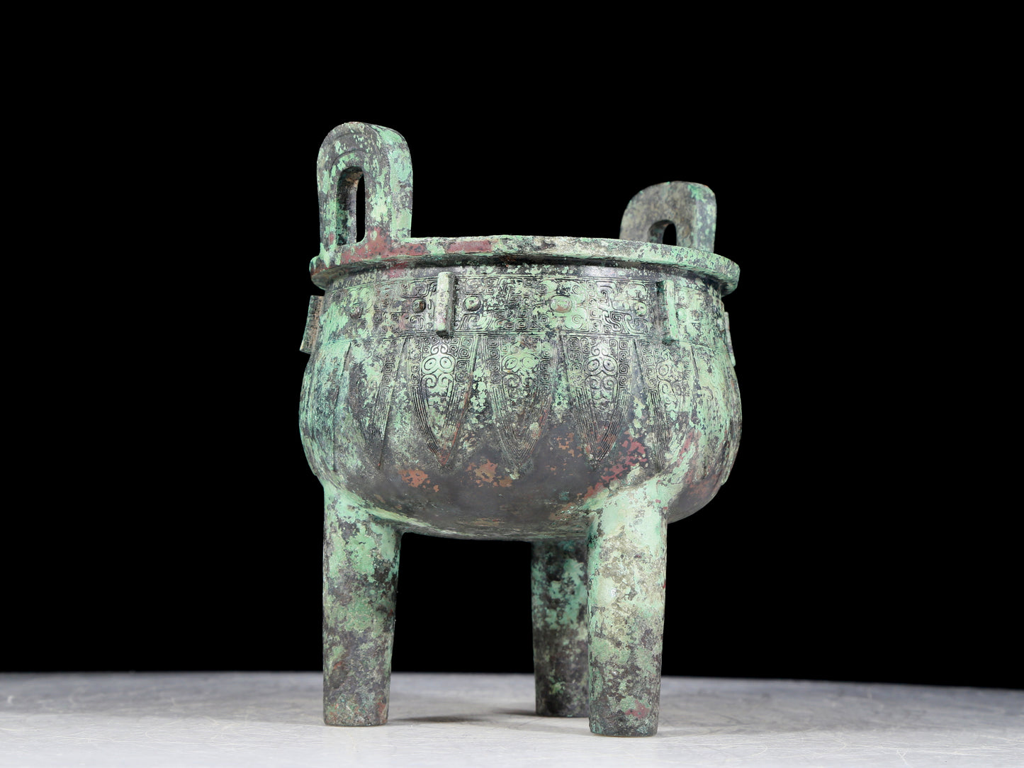 A precious bronze animal-faced two-eared and tripod furnace