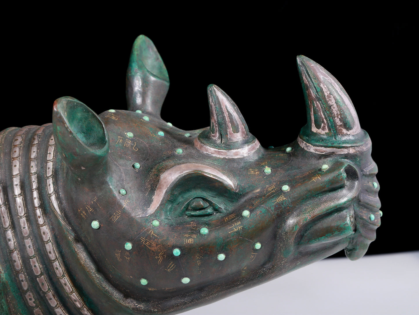 A precious bronze rhinoceros jar inlaid with gold and silver