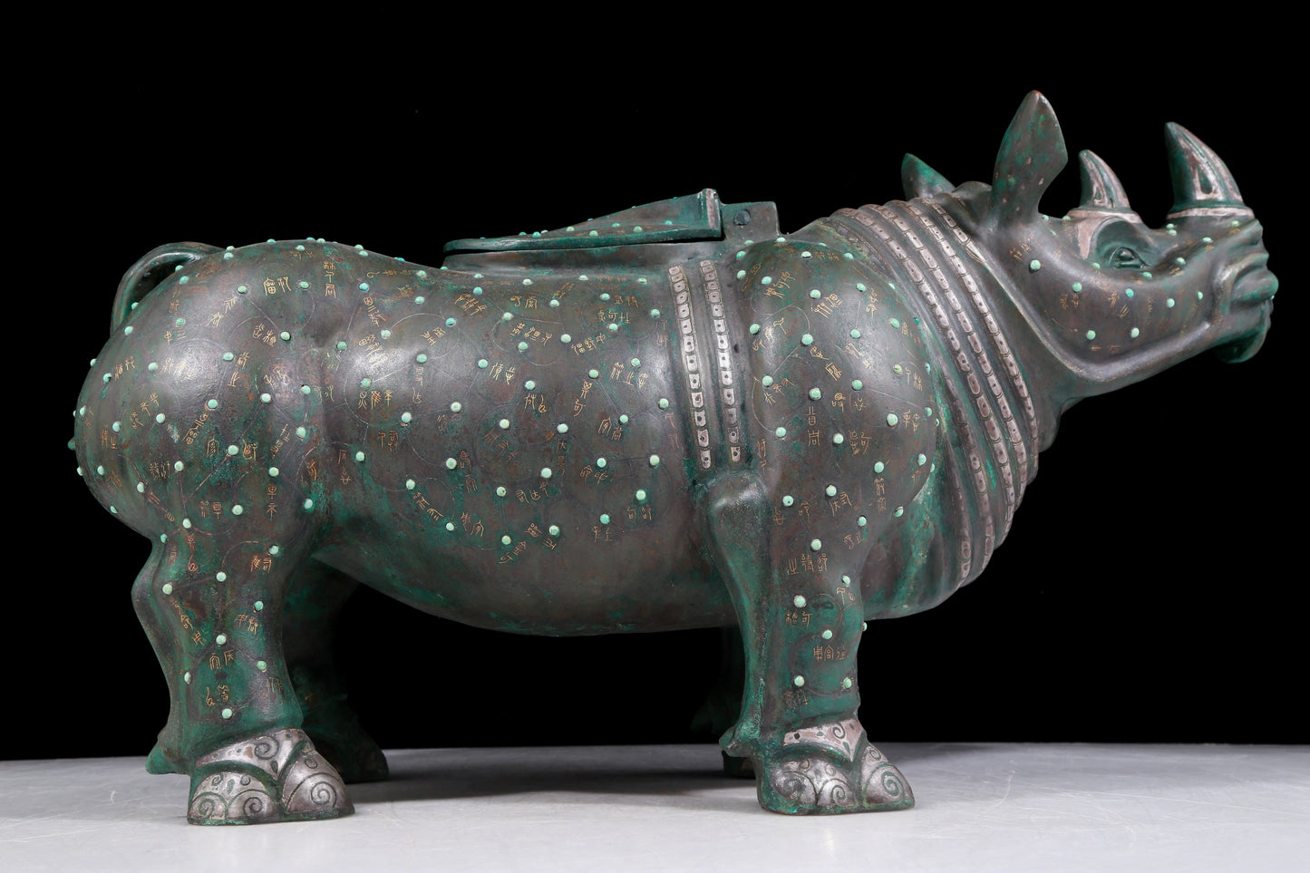 A precious bronze rhinoceros jar inlaid with gold and silver