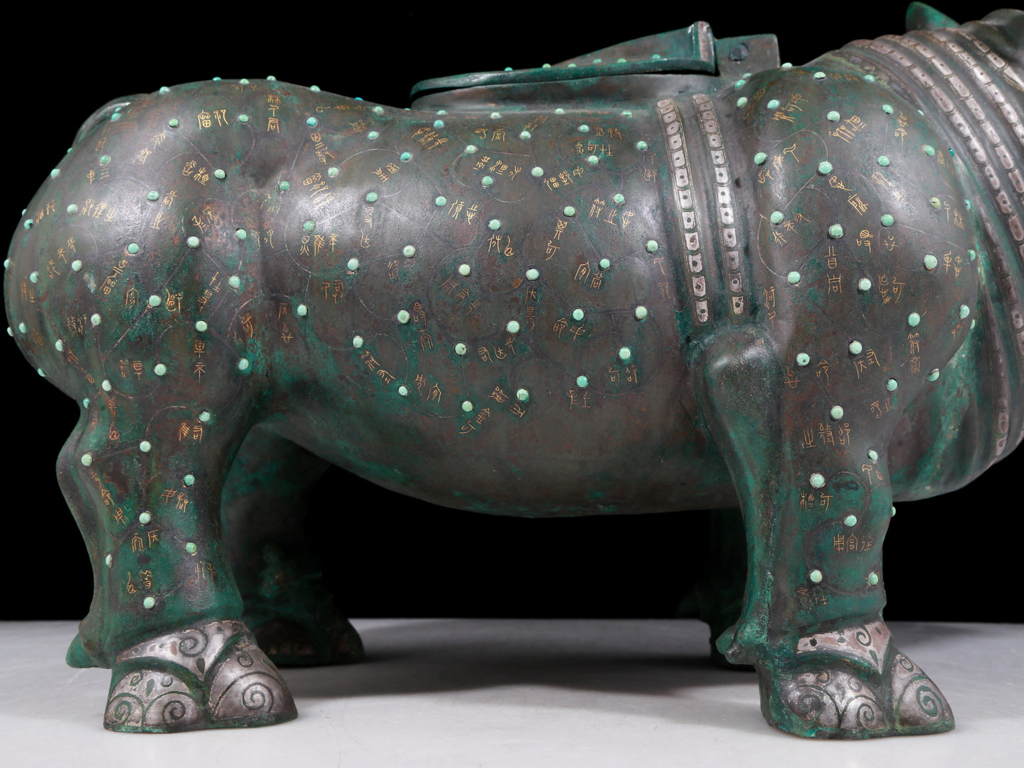 A precious bronze rhinoceros jar inlaid with gold and silver