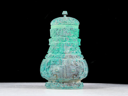 A precious bronze animal mask bottle with lid