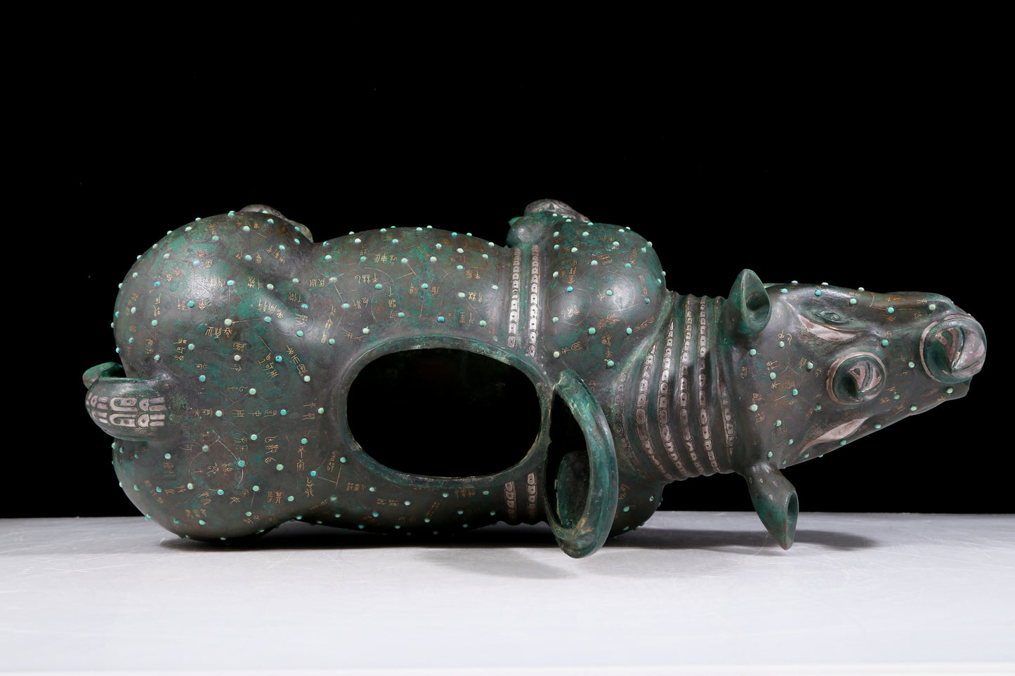 A precious bronze rhinoceros jar inlaid with gold and silver