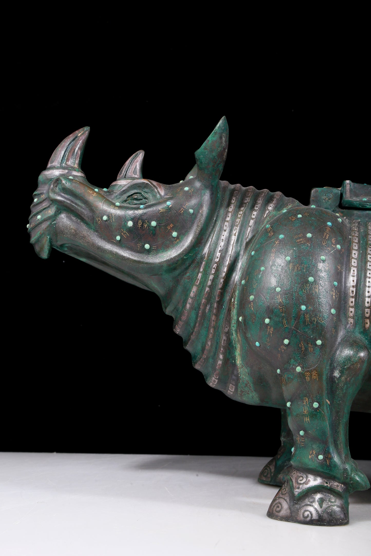 A precious bronze rhinoceros jar inlaid with gold and silver