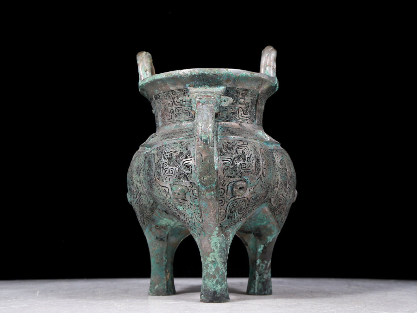 A precious bronze tripod pot with animal masks