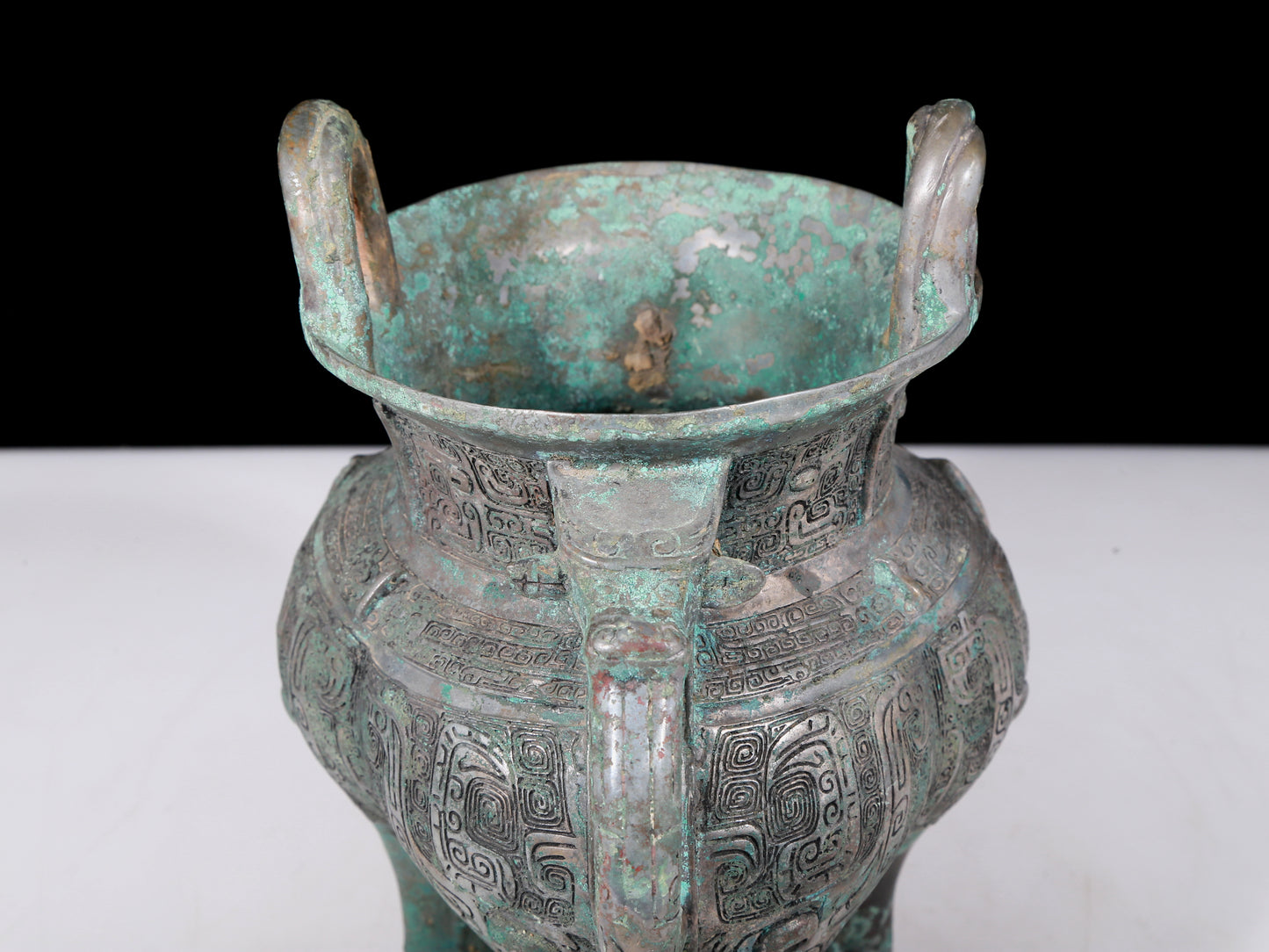 A precious bronze tripod pot with animal masks