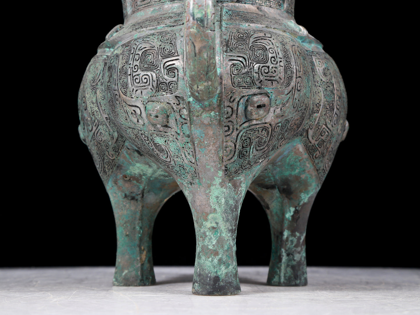 A precious bronze tripod pot with animal masks