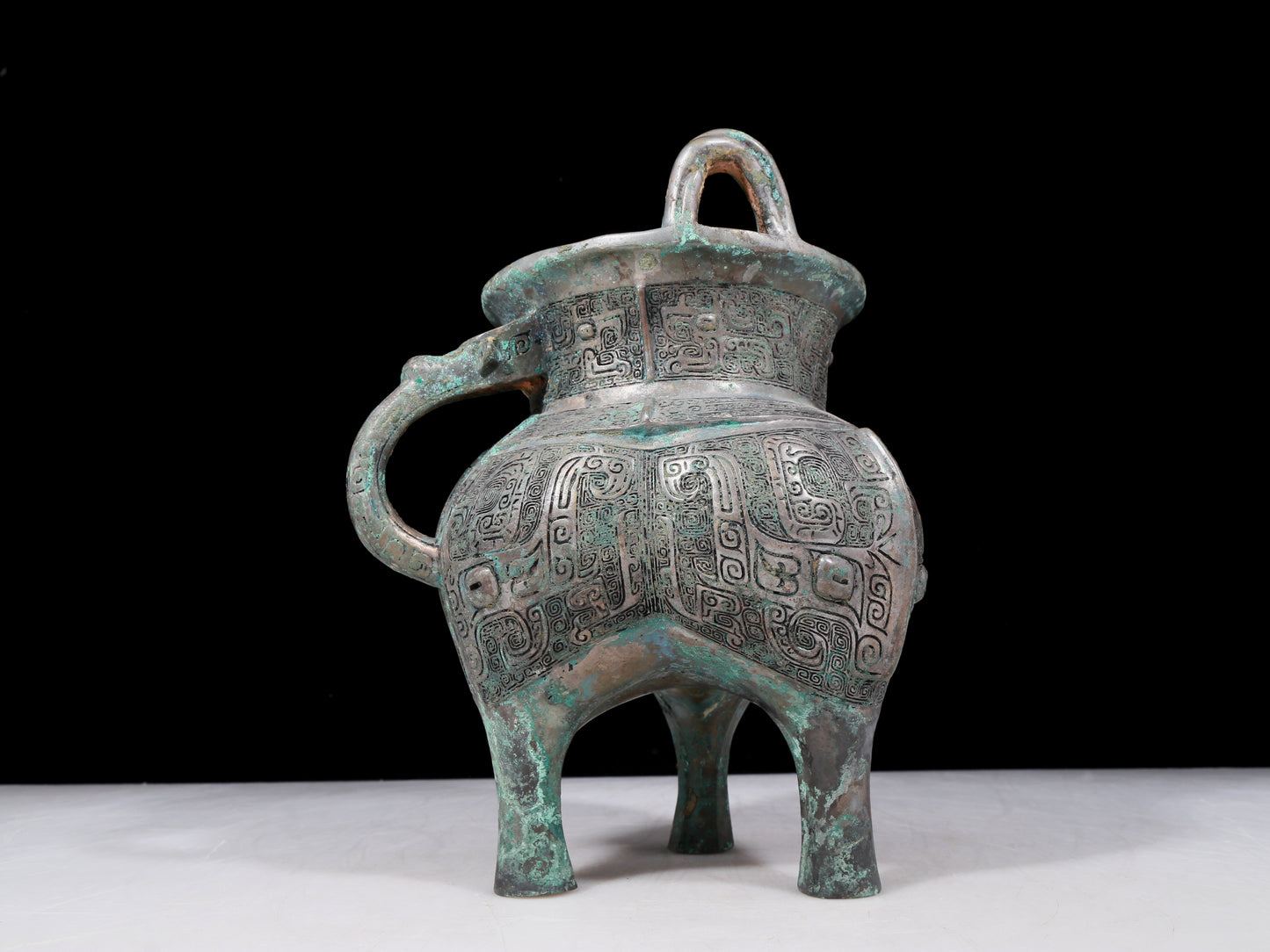 A precious bronze tripod pot with animal masks