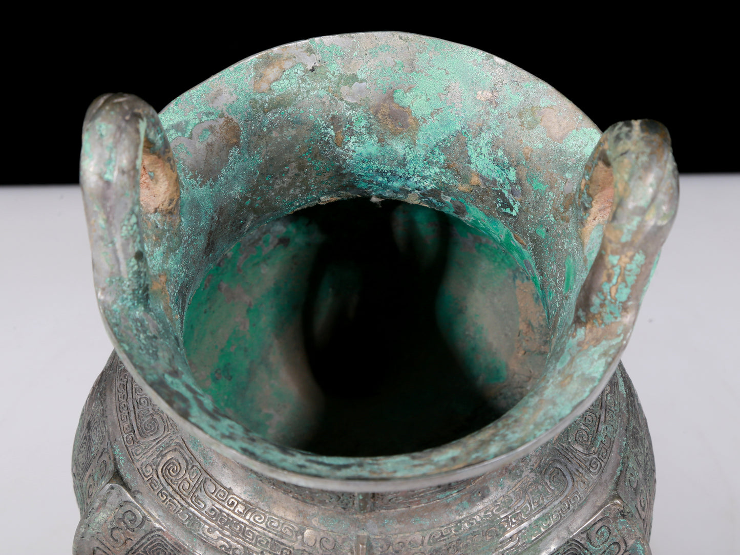 A precious bronze tripod pot with animal masks