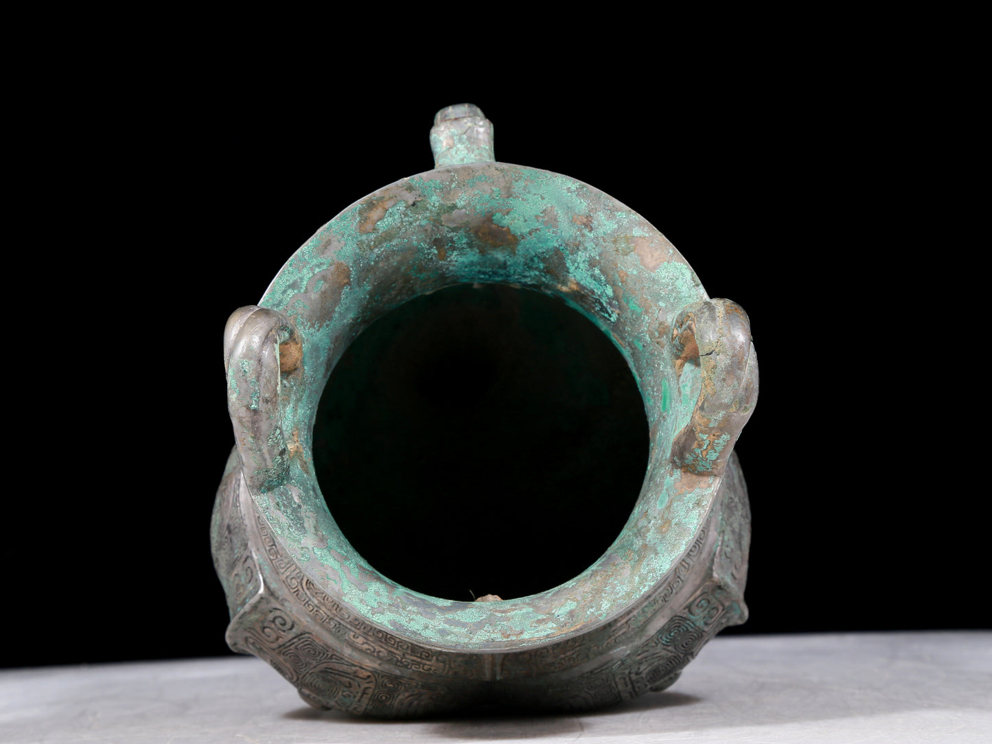 A precious bronze tripod pot with animal masks