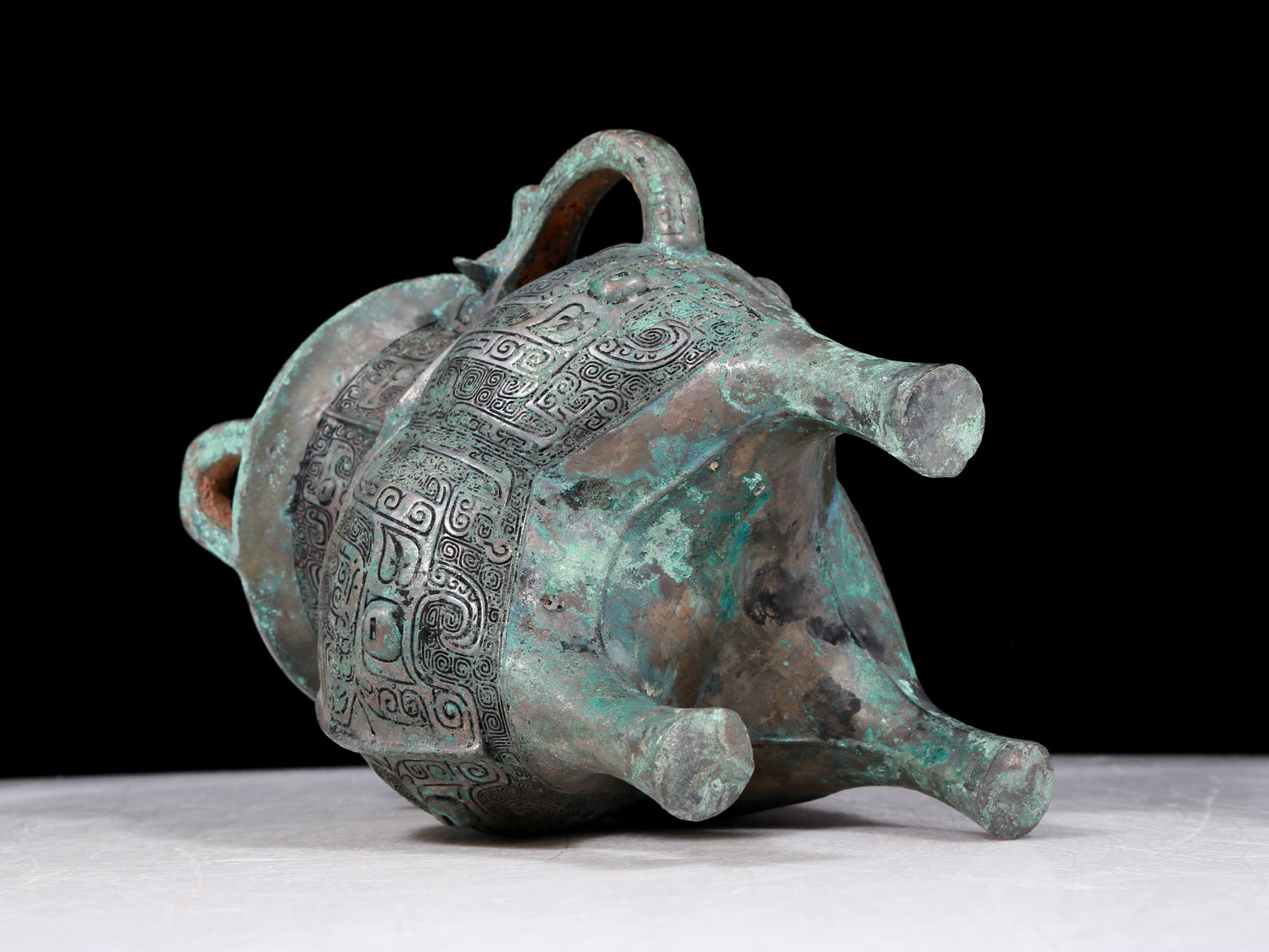 A precious bronze tripod pot with animal masks