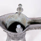 A precious bronze tripod cup with animal masks