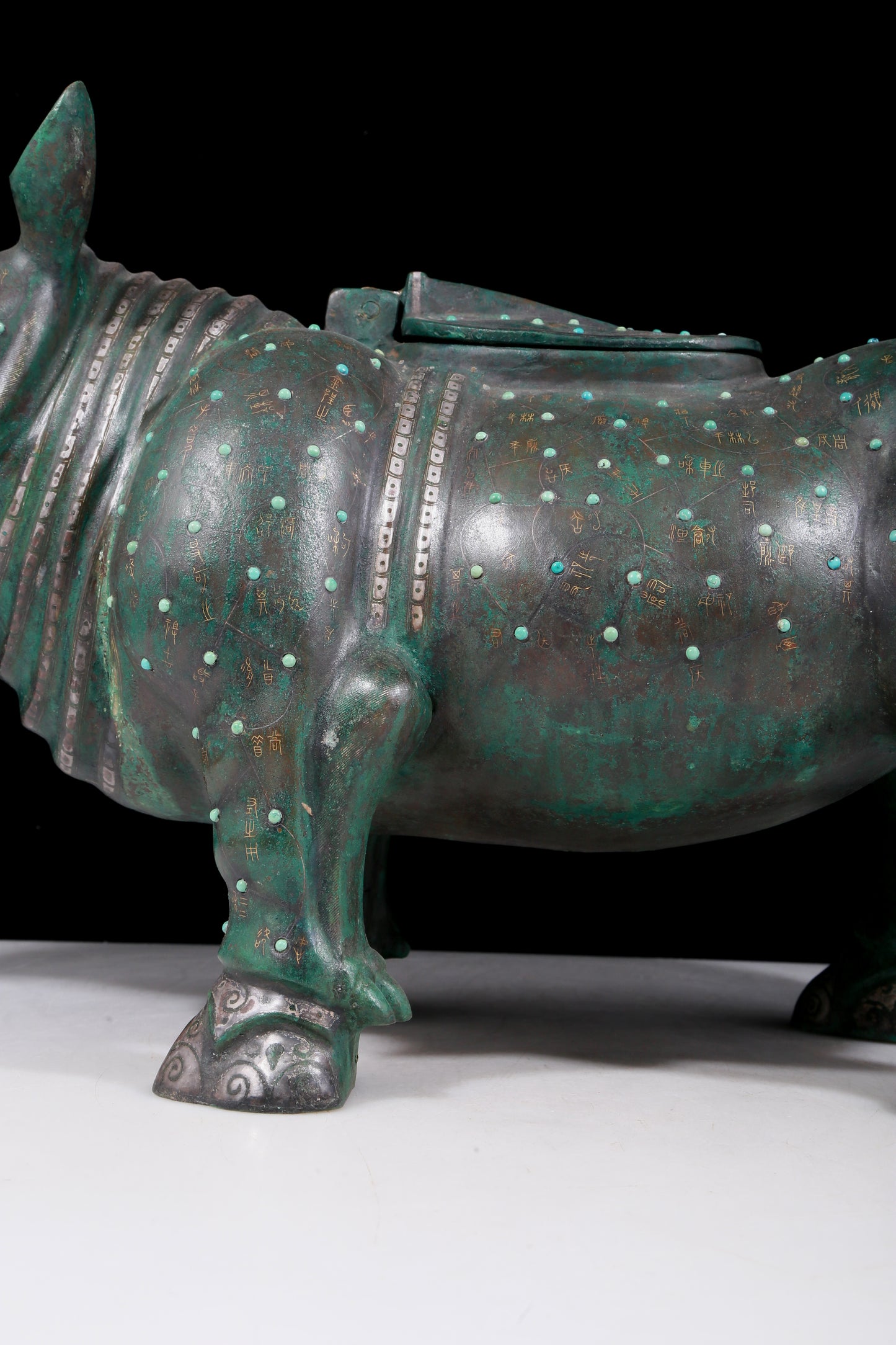 A precious bronze rhinoceros jar inlaid with gold and silver