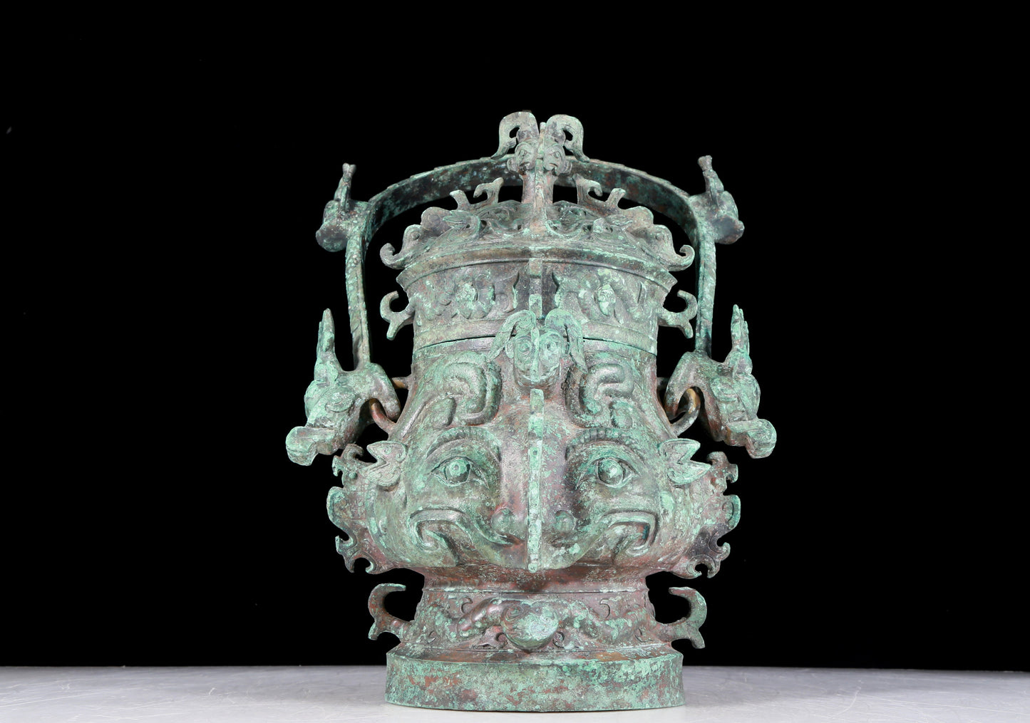 A precious bronze animal-faced pot