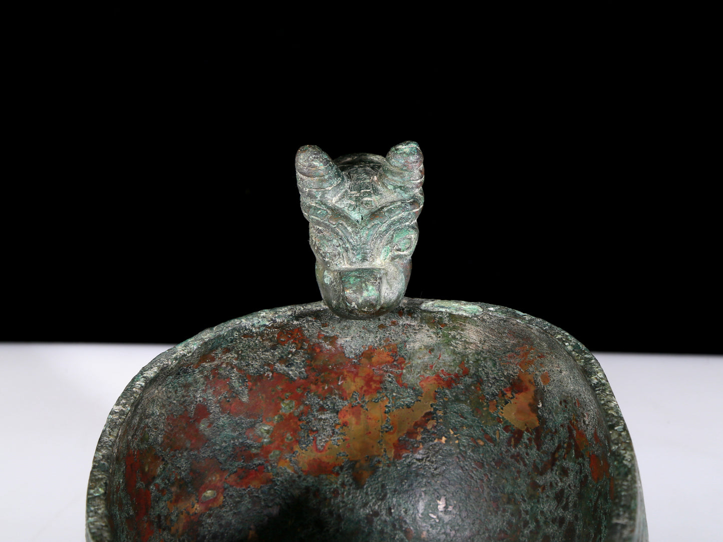 A precious bronze auspicious animal holding pot