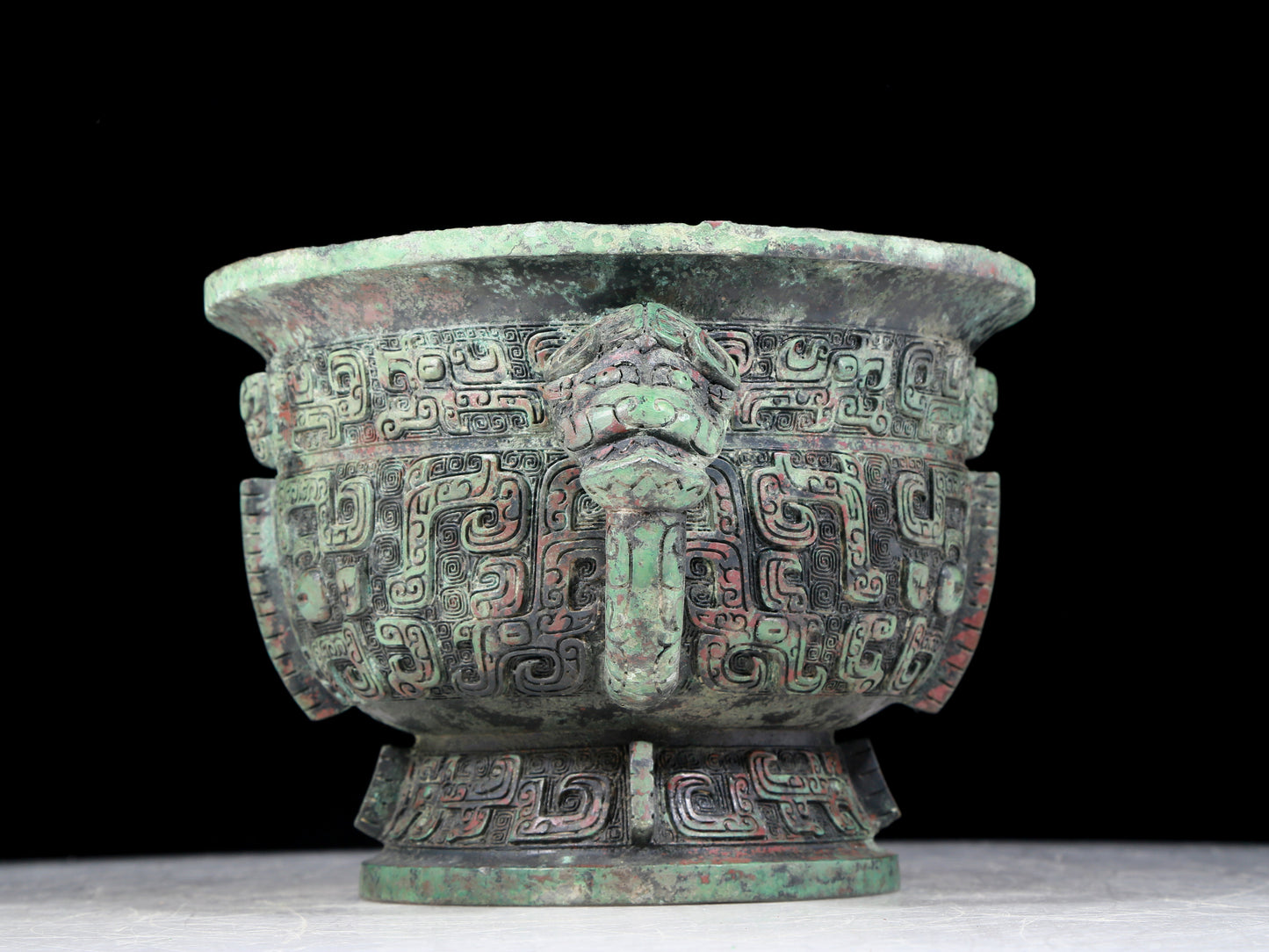 A precious bronze double-eared stove with animal masks