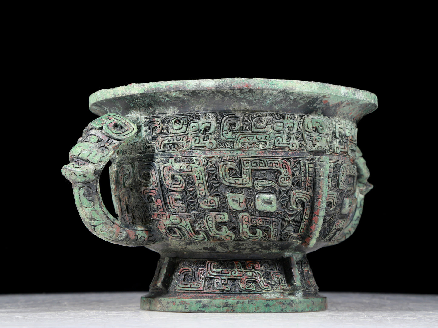 A precious bronze double-eared stove with animal masks