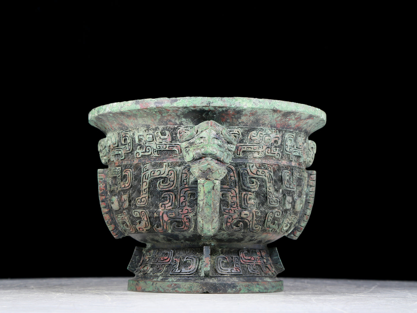 A precious bronze double-eared stove with animal masks