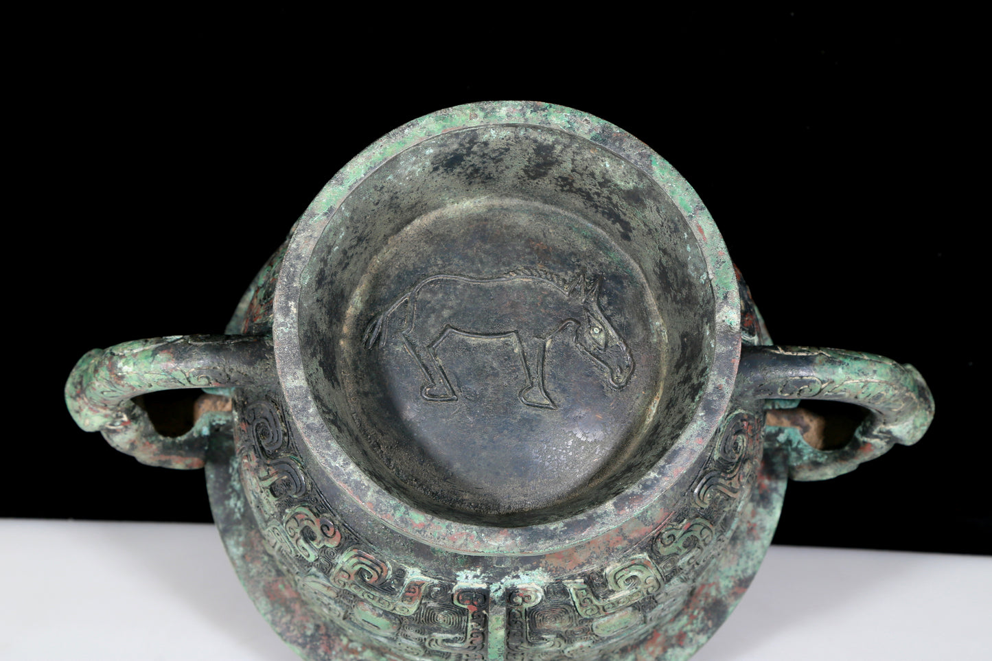 A precious bronze double-eared stove with animal masks