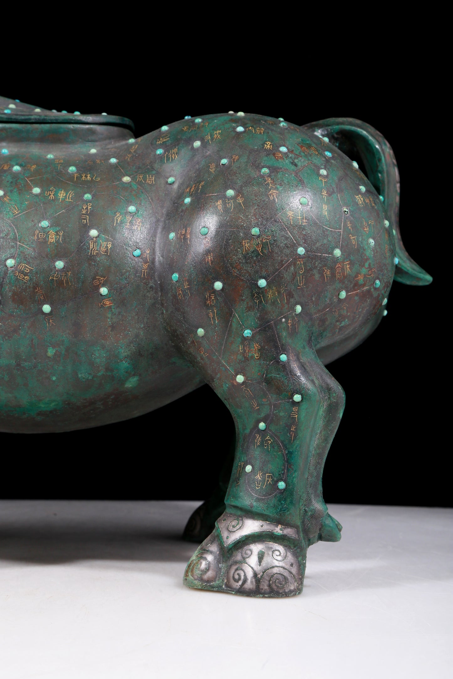 A precious bronze rhinoceros jar inlaid with gold and silver