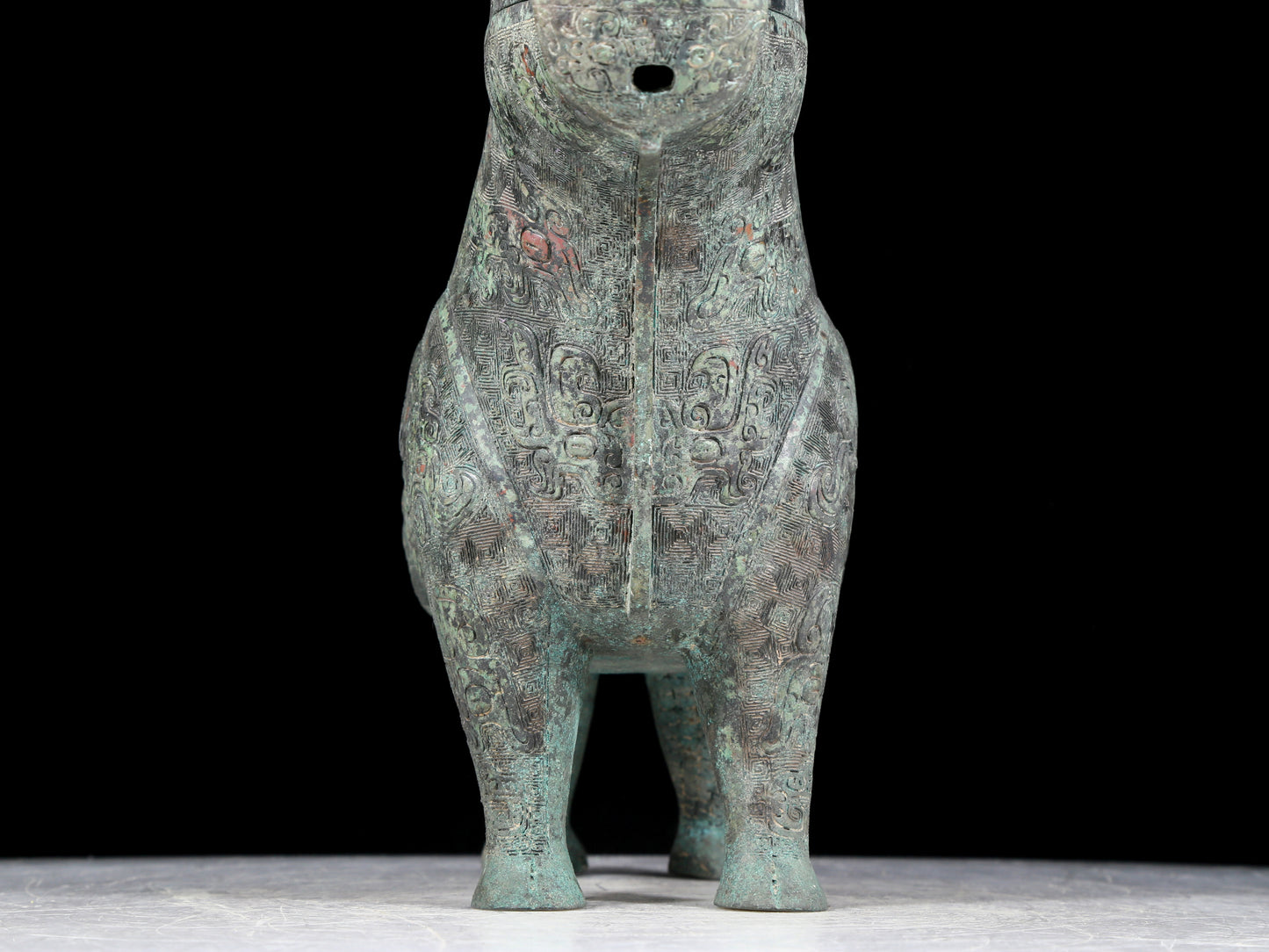 A precious bronze auspicious animal holding pot