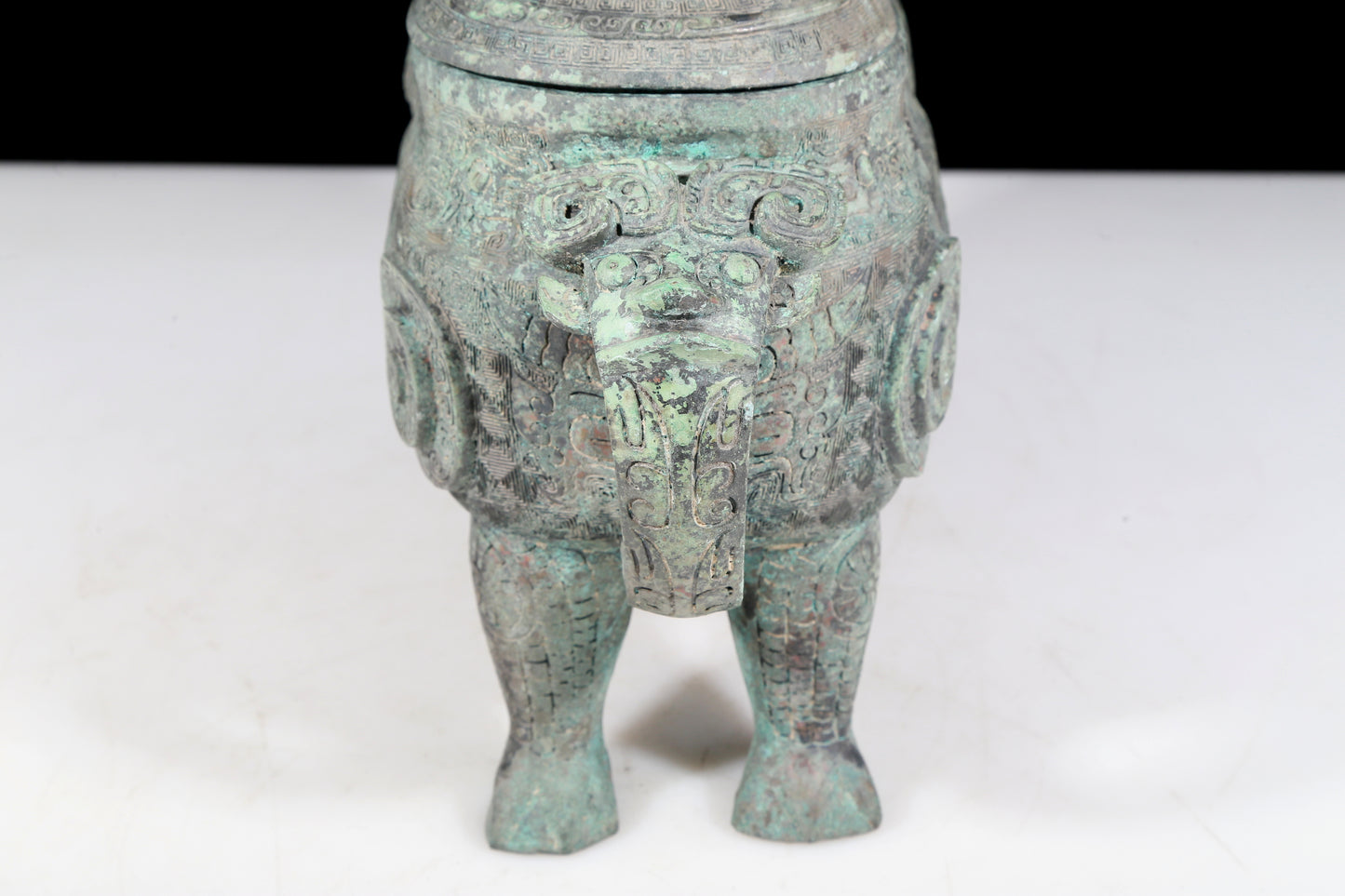 A precious bronze auspicious animal holding pot