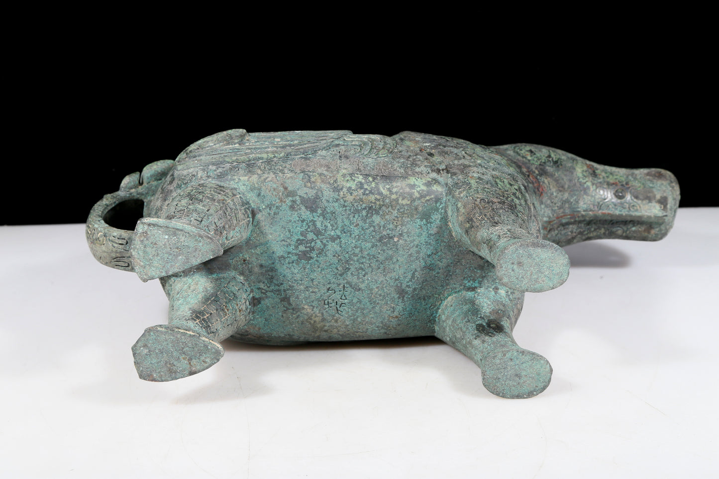 A precious bronze auspicious animal holding pot