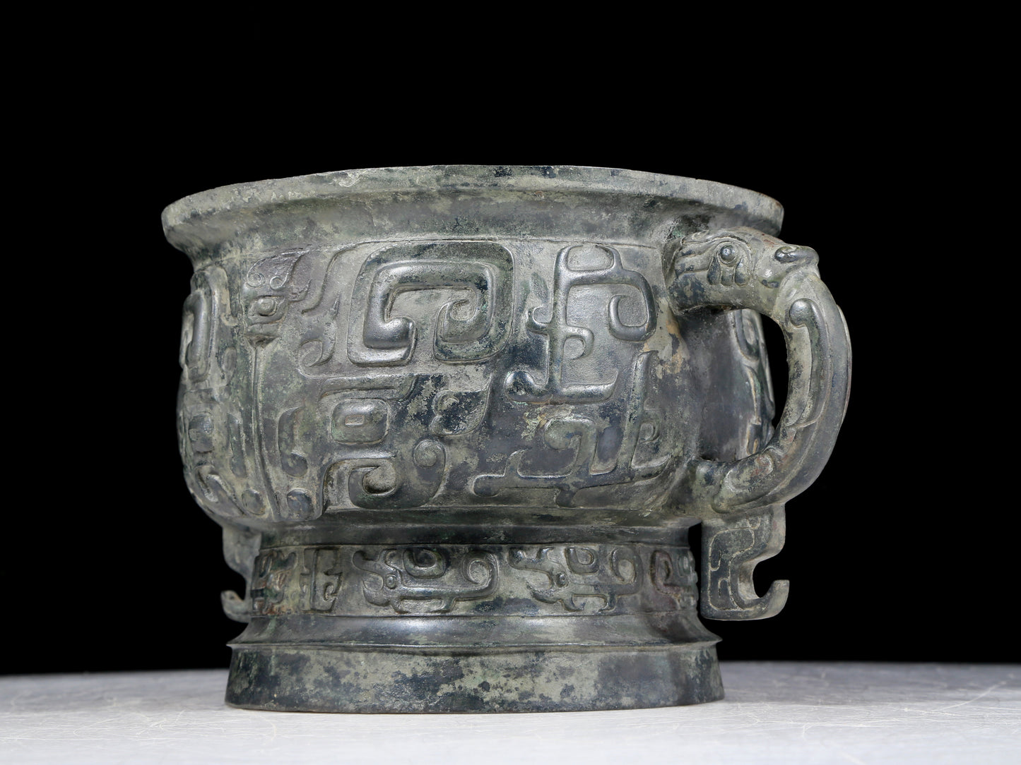 A precious bronze double-eared stove with animal masks