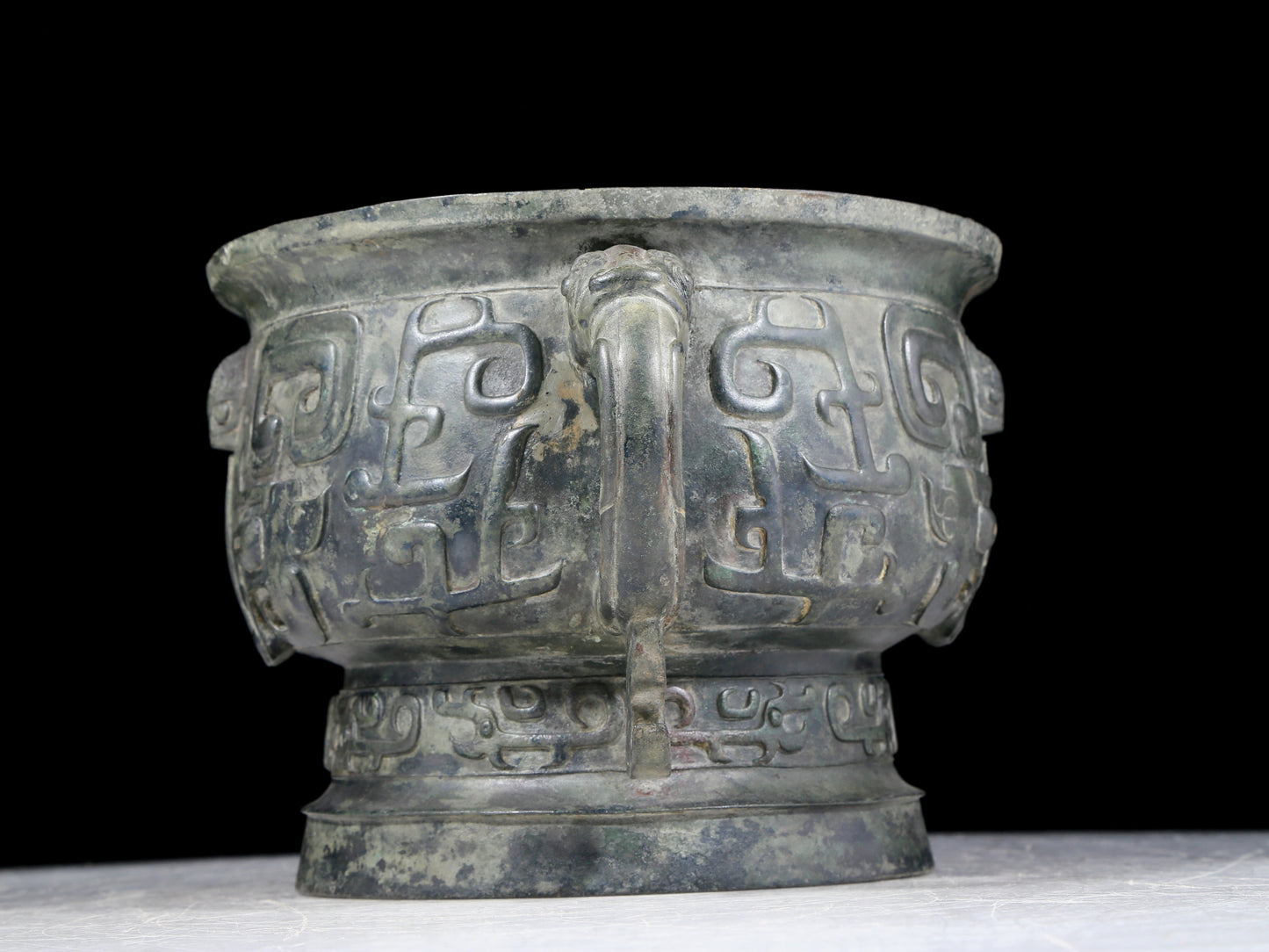 A precious bronze double-eared stove with animal masks