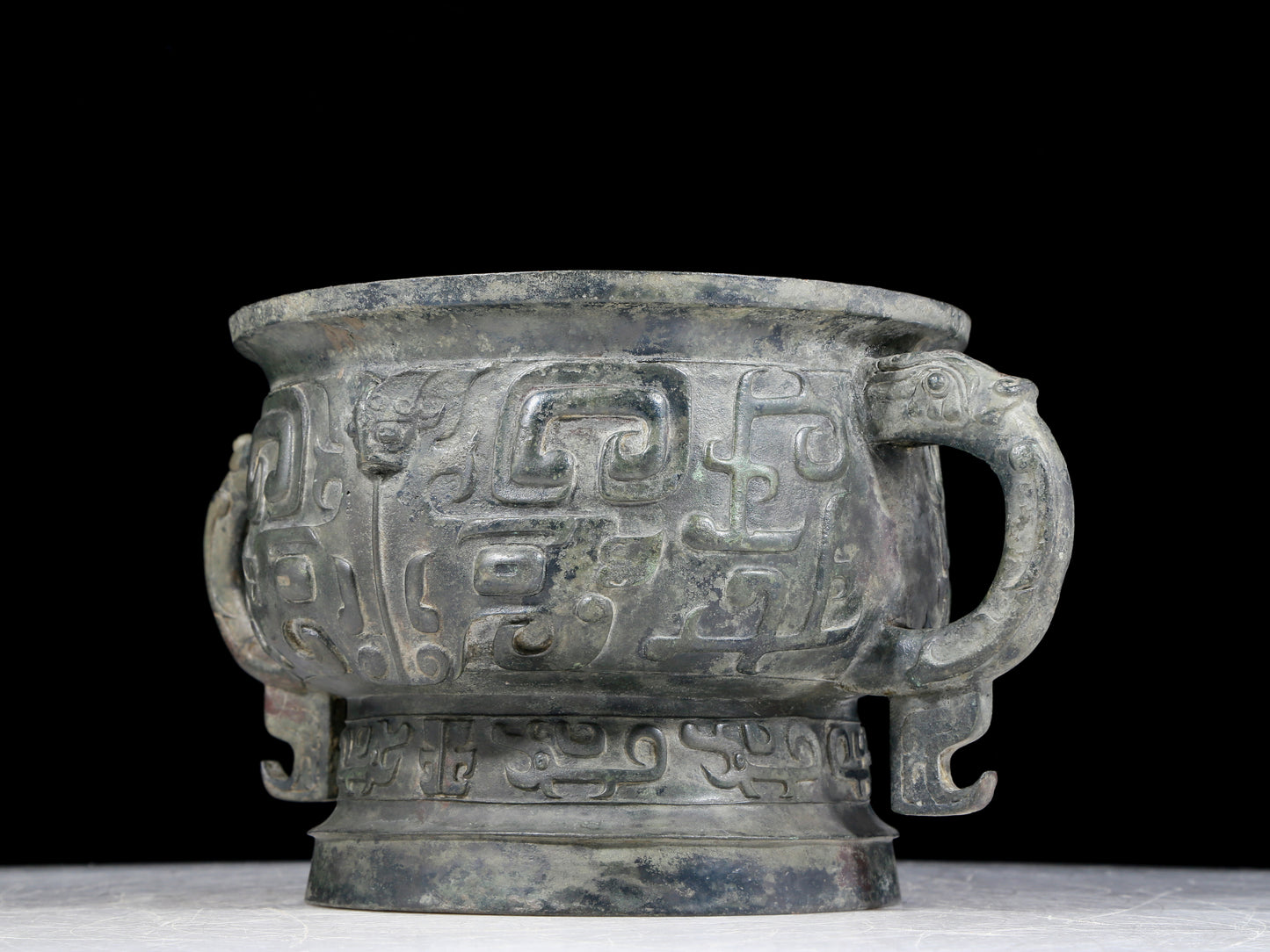 A precious bronze double-eared stove with animal masks