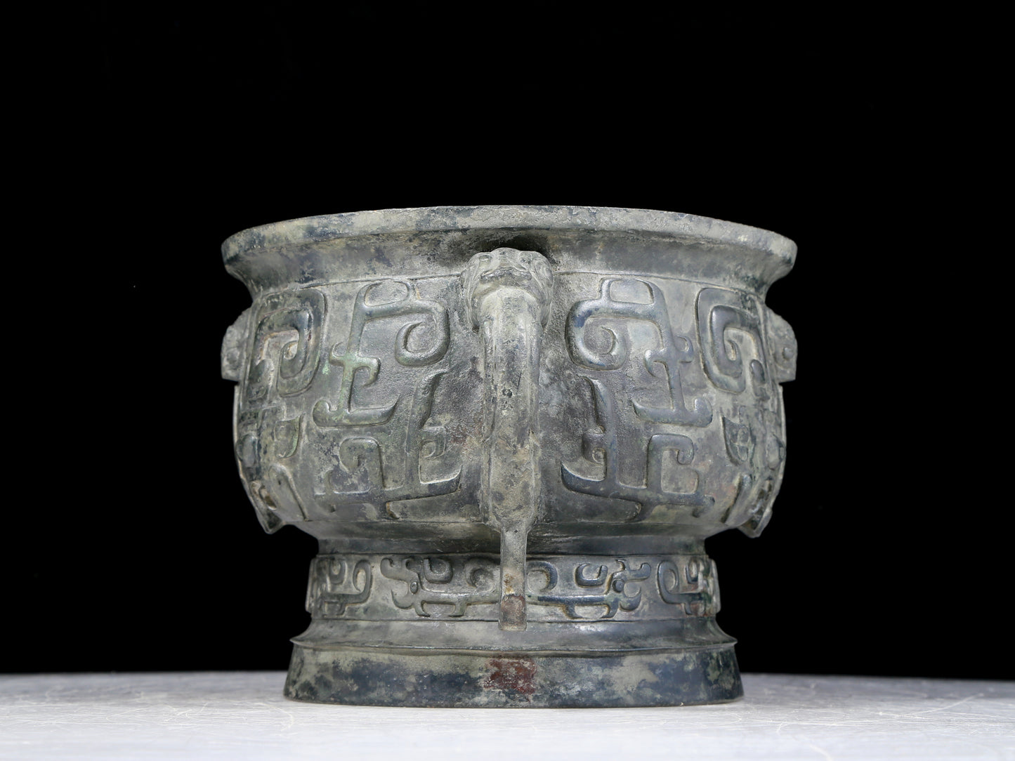 A precious bronze double-eared stove with animal masks