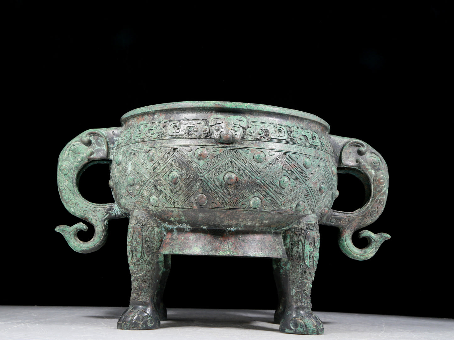 A rare bronze animal-mask elephant-ear censer