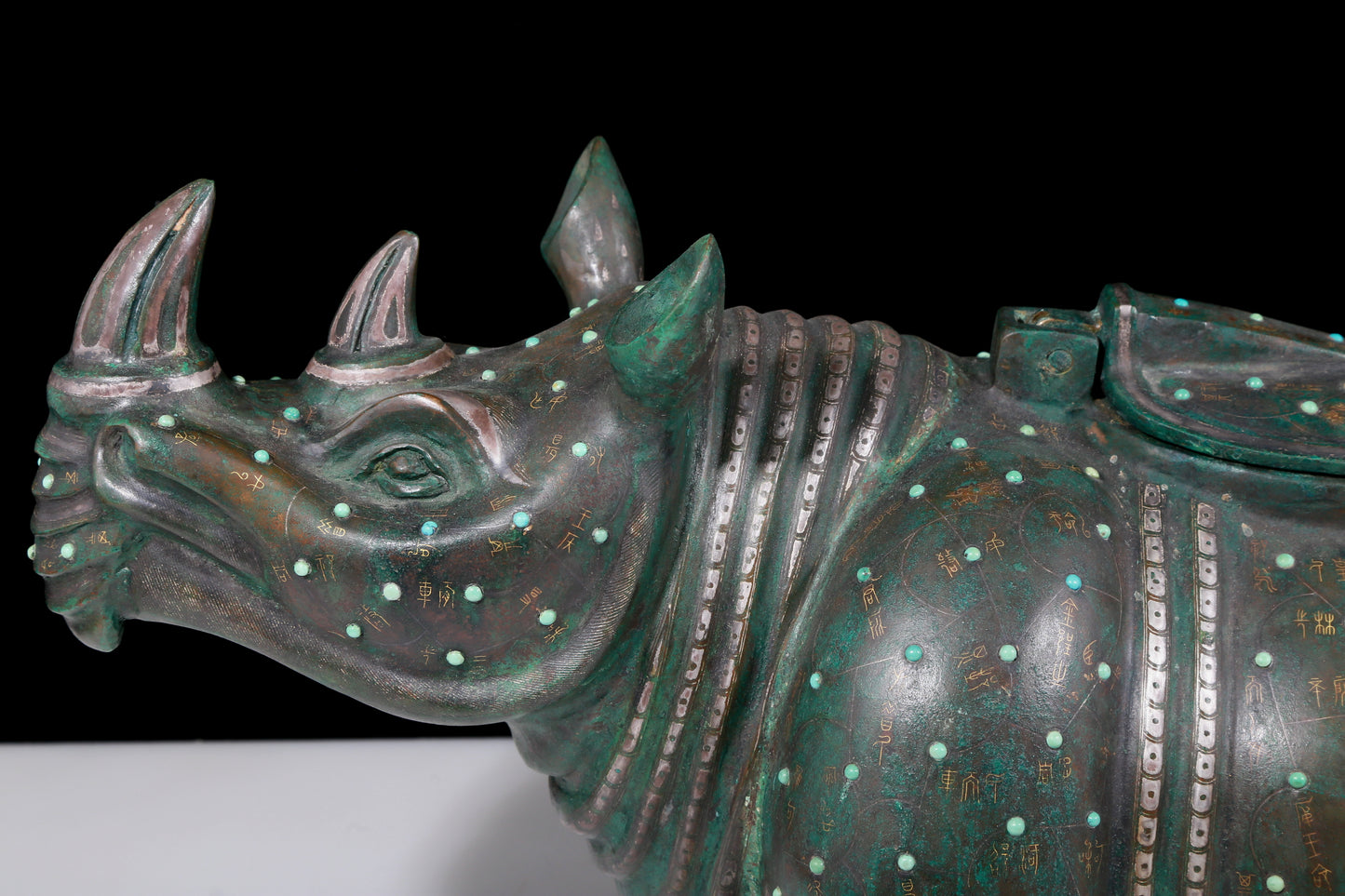 A precious bronze rhinoceros jar inlaid with gold and silver