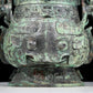 A precious bronze animal-faced pot