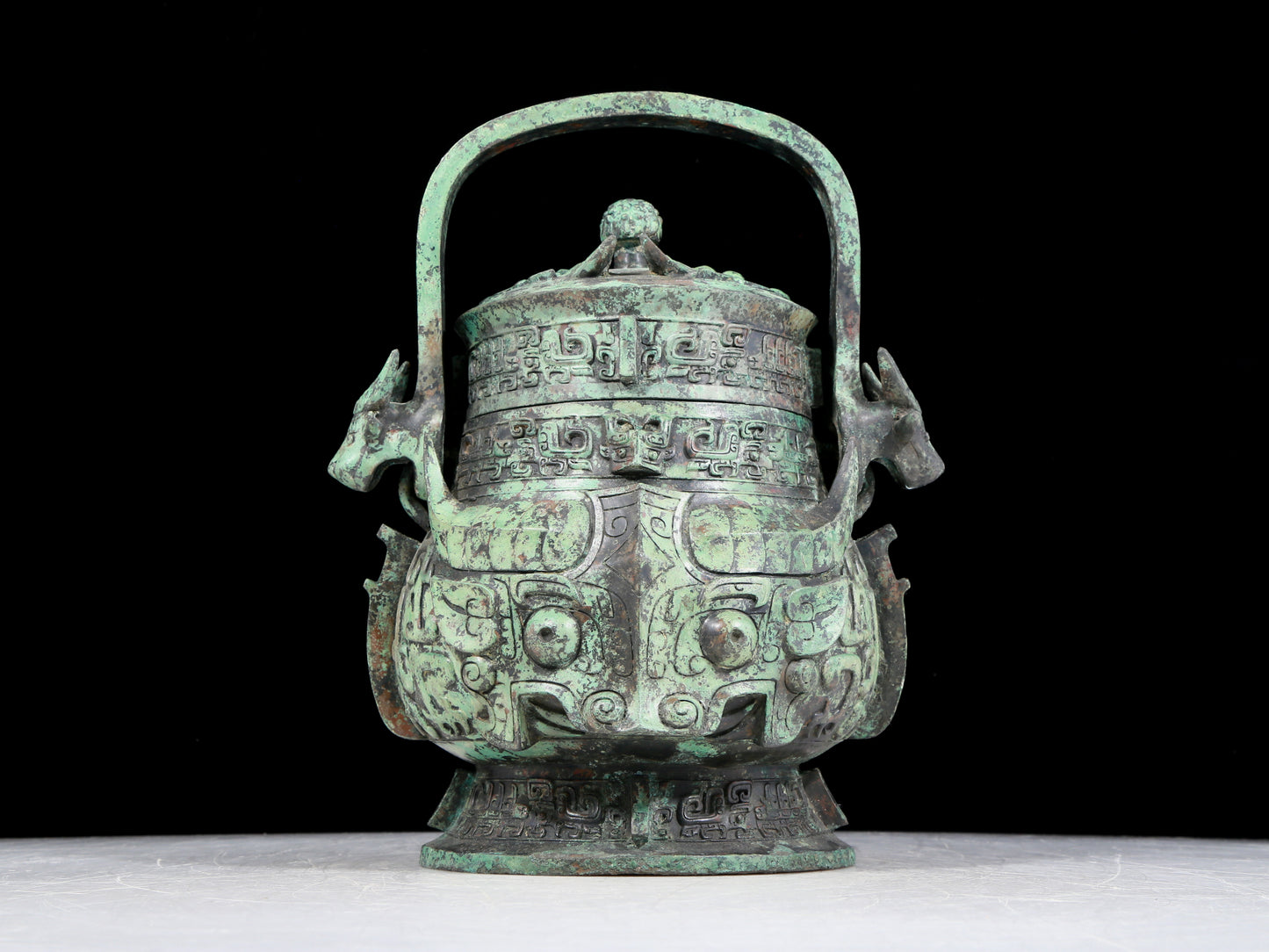 A precious bronze animal-faced pot