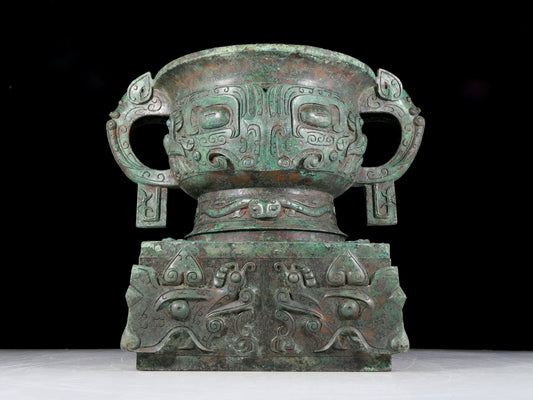 A precious bronze double-eared stove with animal masks