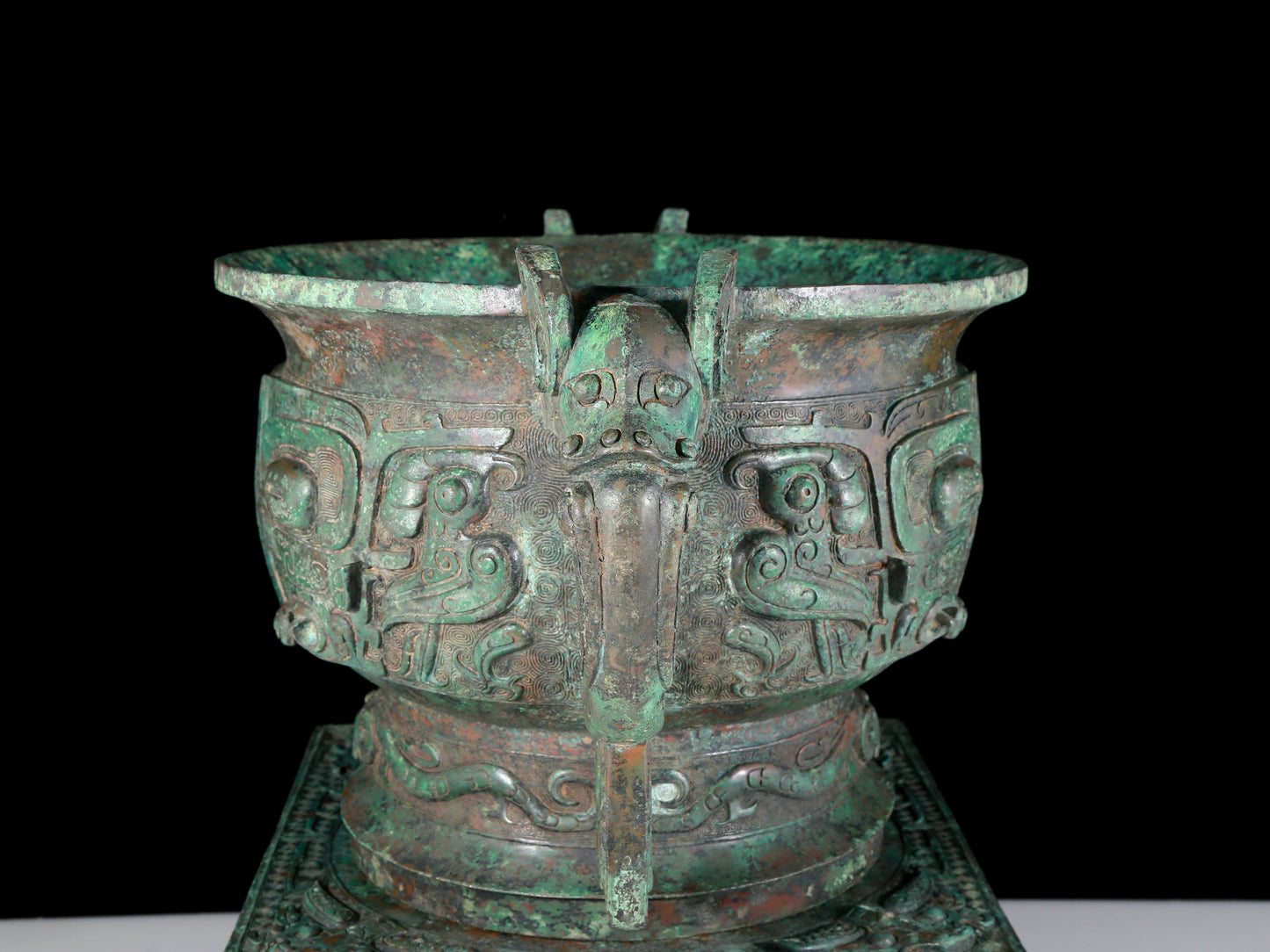 A precious bronze double-eared stove with animal masks