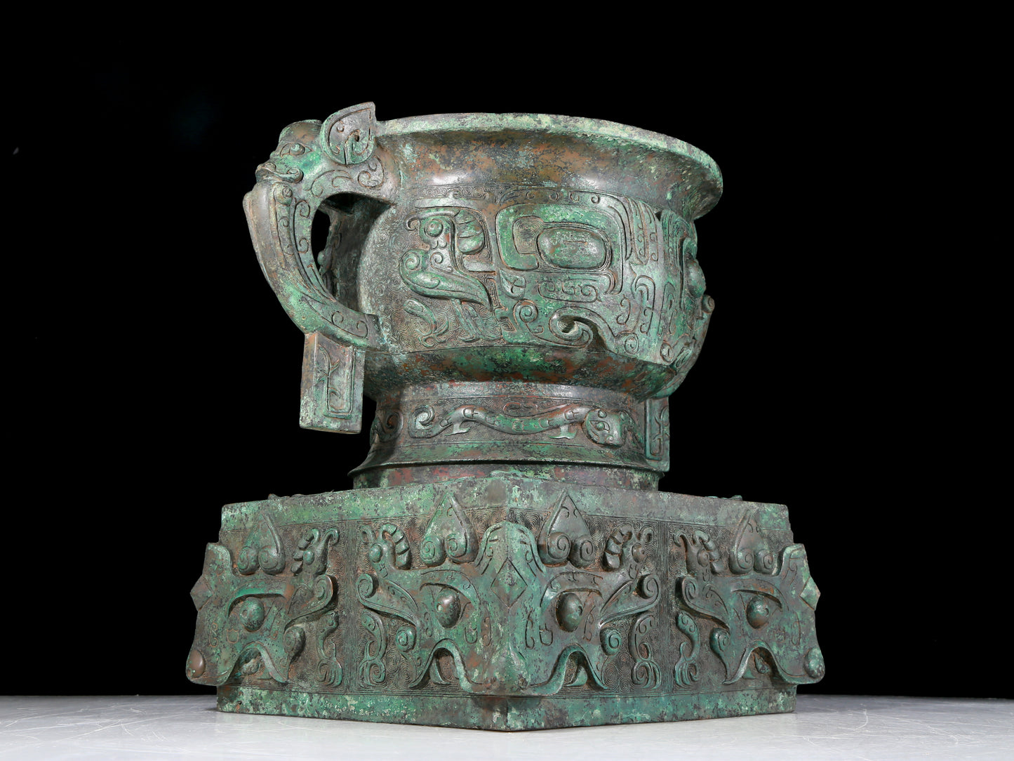 A precious bronze double-eared stove with animal masks