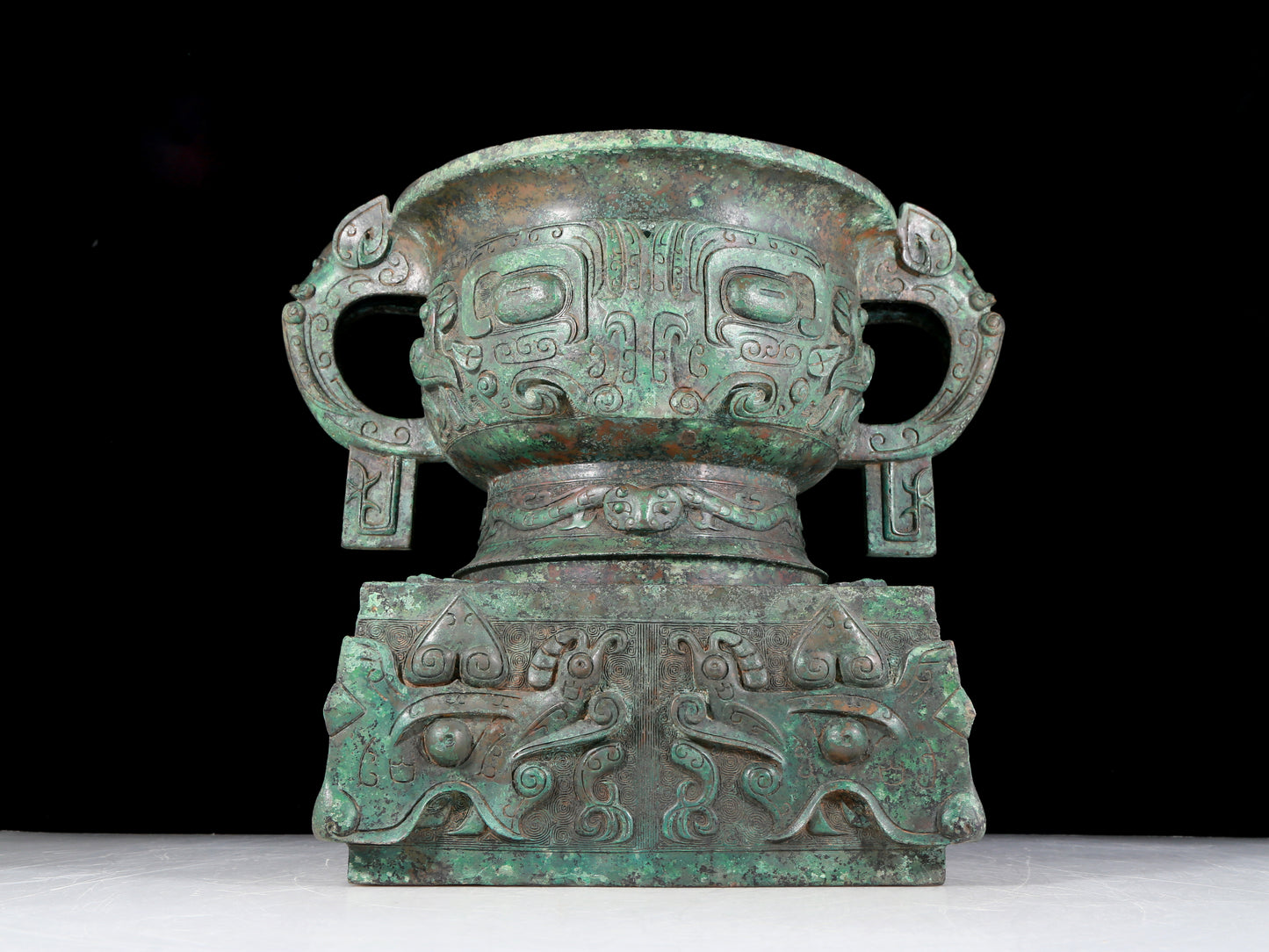 A precious bronze double-eared stove with animal masks