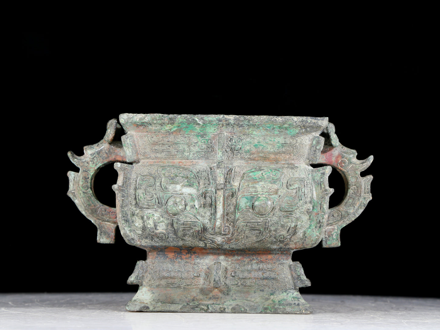 A precious bronze double-eared stove with animal masks