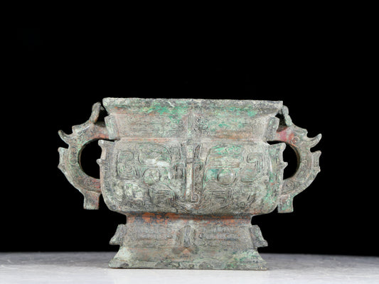 A precious bronze double-eared stove with animal masks