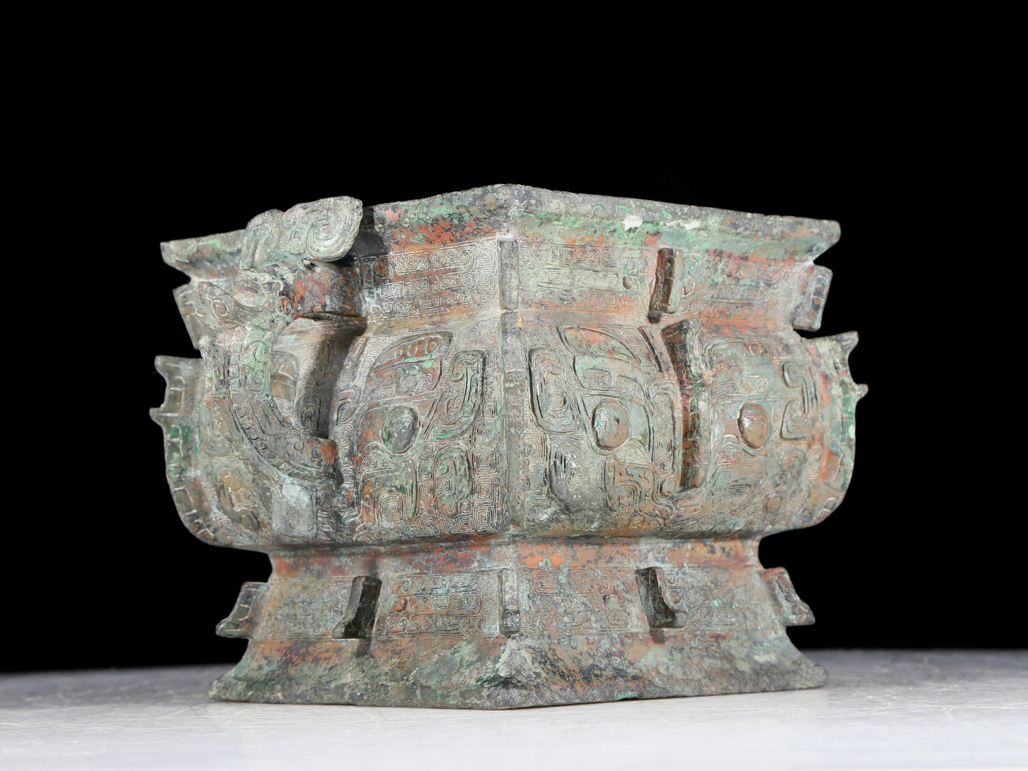 A precious bronze double-eared stove with animal masks