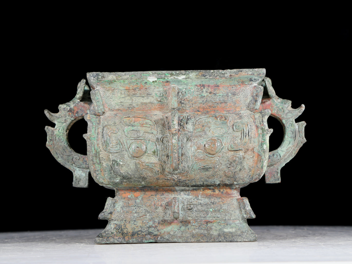 A precious bronze double-eared stove with animal masks