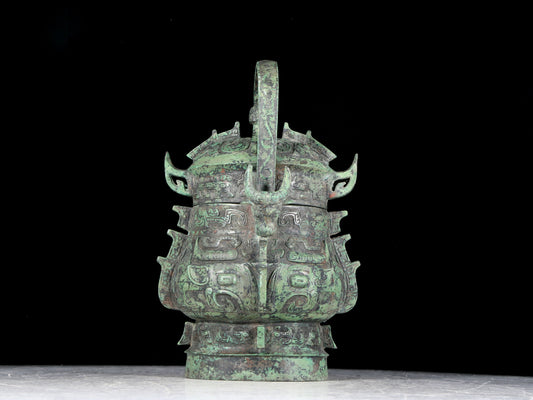 A precious bronze animal-faced pot