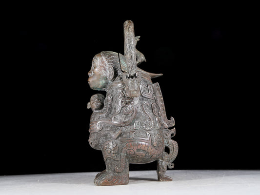 A precious bronze figure carrying a kettle