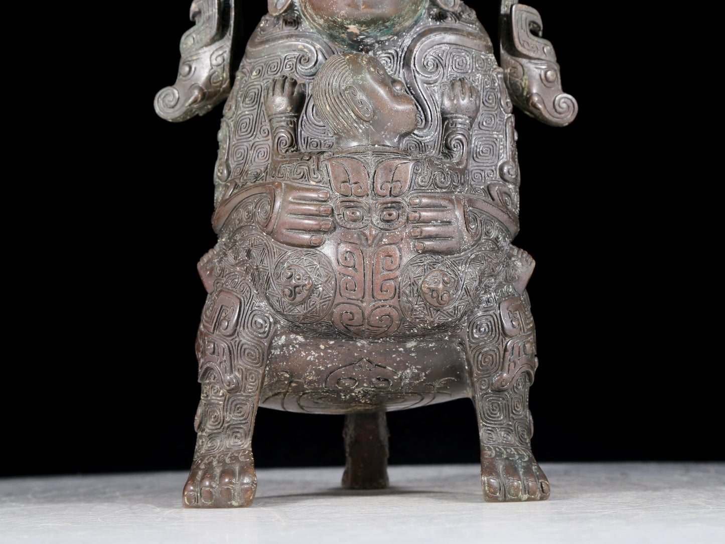 A precious bronze figure carrying a kettle