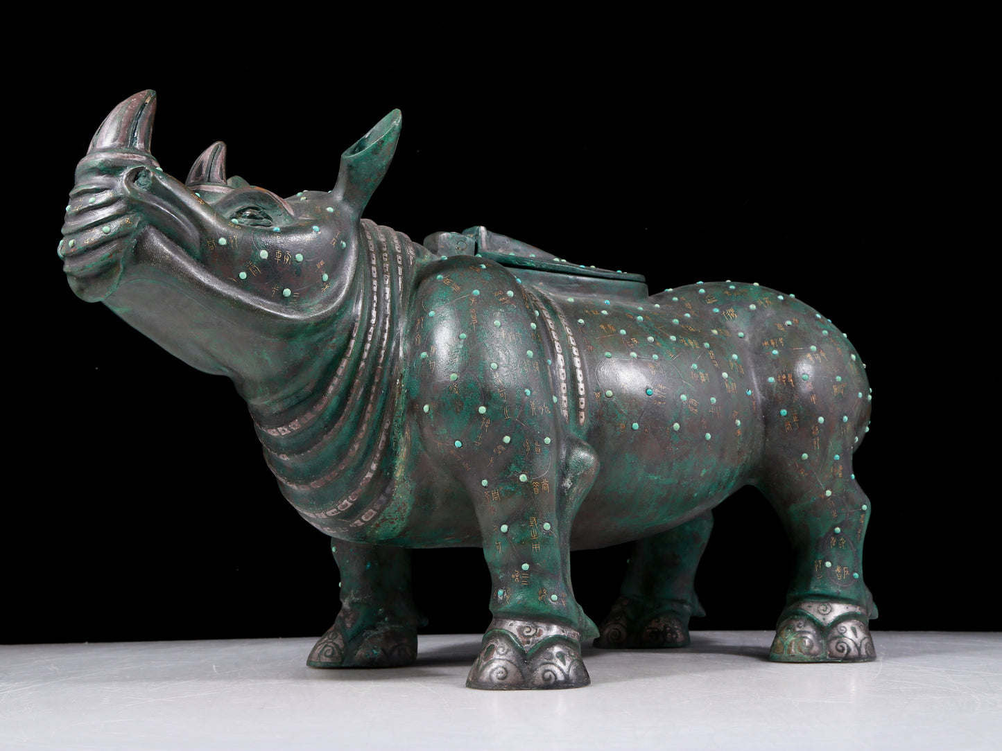 A precious bronze rhinoceros jar inlaid with gold and silver